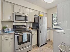 Daphne apartment for rent - a kitchen with stainless steel appliances and white cabinets