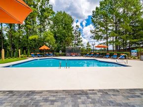 Hoover apartment for rent - a swimming pool with chairs and umbrellas next to a resort style pool