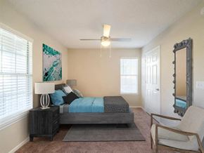 Hoover apartment for rent - a bedroom with a bed and a ceiling fan