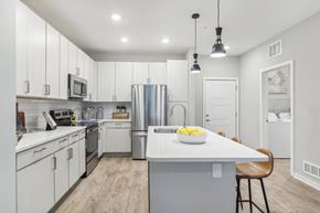 Apollo Beach apartment for rent - a large kitchen with white cabinets and stainless steel appliances