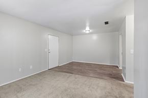 Opelika apartment for rent - A room with a carpeted floor and a ceiling fan.