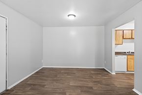 Opelika apartment for rent - A room with a white wall and a wooden floor.