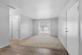 Opelika apartment for rent - A room with white walls and a wooden floor.