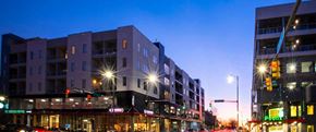 Birmingham apartment for rent - Mixed use development exterior at dusk with retail shops at Reserve on 3rd Apartments, Alabama