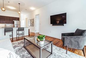 Birmingham apartment for rent - Open concept living area with kitchen breakfast bar at Reserve on 3rd Apartments, Birmingham, AL 35233