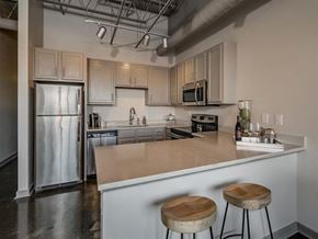 Tuscaloosa apartment for rent - Fitted Kitchen With Island Dining at The Tower Apartments, Alabama, 35401