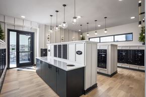 Broomfield apartment for rent - A modern kitchen with black and white cabinets and wooden floors.