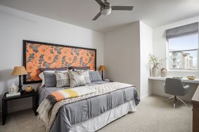 Broomfield apartment for rent - A bedroom with a large bed and a painting on the wall.