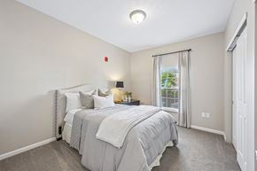 Columbus apartment for rent - A bedroom with a large bed and a window with curtains.