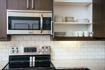 A kitchen with a stove and a microwave