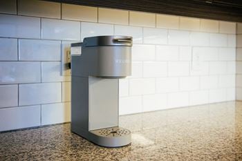 A stainless steel coffee maker on a counter in a kitchen