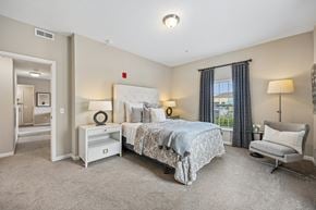 Columbus apartment for rent - A bedroom with a large bed and a chair.