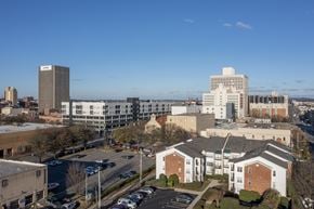 Birmingham apartment for rent - A cityscape with buildings and cars.