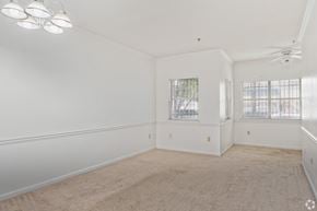 Birmingham apartment for rent - A spacious room with a carpeted floor and a ceiling fan.