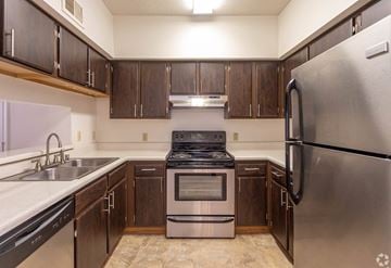 Birmingham apartment for rent - A kitchen with a stainless steel refrigerator, sink, and stove.