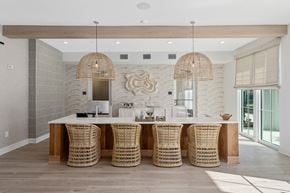 Orange Beach apartment for rent - A dining room with a white table and chairs with a wooden top.