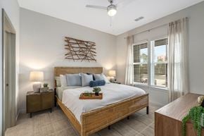 Orange Beach apartment for rent - A bedroom with a large bed and a wooden headboard.