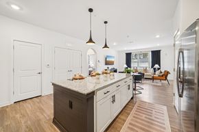 Birmingham apartment for rent - A kitchen with a large island and a refrigerator on the right.