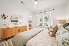 Birmingham apartment for rent - A bedroom with a large bed and a wooden cabinet.