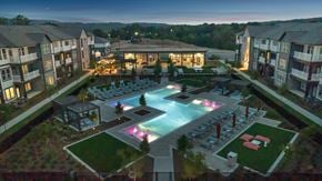 Homewood apartment for rent - A beautifully lit outdoor pool area at dusk in a residential complex.