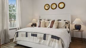 Homewood apartment for rent - A bedroom with a large bed and a window with curtains.