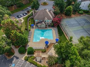 Alpharetta apartment for rent - A large house with a pool and tennis court.