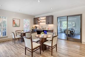 Alpharetta apartment for rent - A modern dining room with a wooden table and chairs.