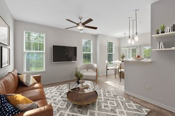 Daphne apartment for rent - A living room with a brown leather couch and a white armchair.