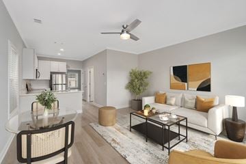 Foley apartment for rent - A modern living room with a glass table and a white couch.