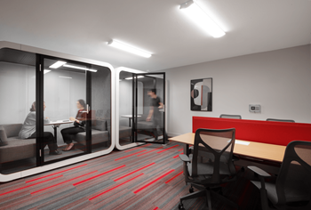 A room with a table and chairs and a red divider