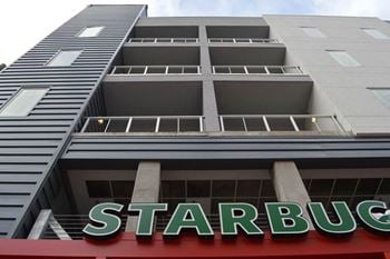 A building with a starbucks sign on the side of it