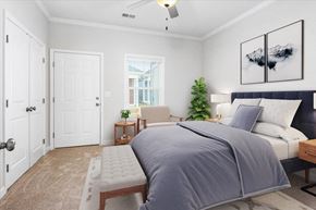 Huntsville apartment for rent - Bedroom with ceiling fan and patio access at Cottages at Oak Grove Dairy in Huntsville, AL
