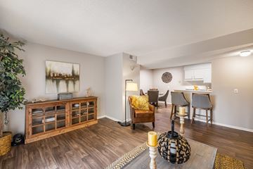 Tuscaloosa apartment for rent - A living room with a wooden floor and a painting on the wall.