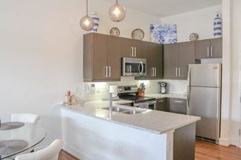 A kitchen with stainless steel appliances and a counter top
