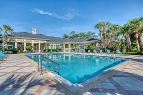 Port Orange apartment for rent - A large swimming pool with a building in the background.