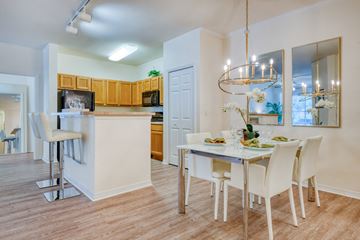 Port Orange apartment for rent - A dining room with a table set for two with a chandelier hanging above.