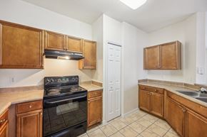 Port Orange apartment for rent - a kitchen with wooden cabinets and a stove and a sink
