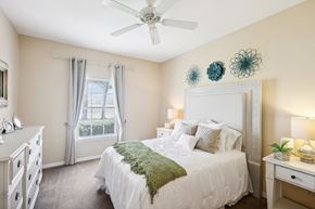 Port Orange apartment for rent - a bedroom with a bed and a ceiling fan