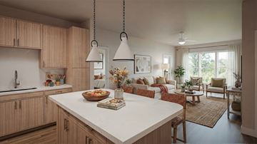 Lutz apartment for rent - A kitchen with wooden cabinets and a white island with a book on it.