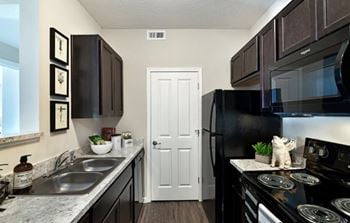 Modern black kitchen appliances with built-in microwaves