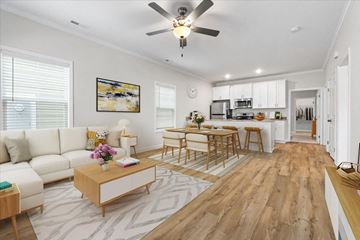 Huntsville apartment for rent - A modern living room with a white sofa and a wooden coffee table.