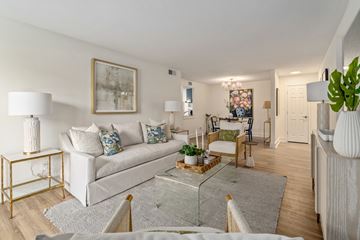 Mobile apartment for rent - A living room with a white couch and a glass coffee table.