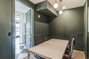 Mcdonough apartment for rent - a dining room with a white table and chairs and a green wall