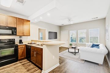 Mobile apartment for rent - A kitchen with wooden cabinets and a black oven.