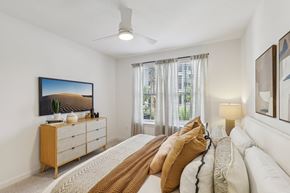 St. Augustine apartment for rent - A bedroom with a large bed and a painting on the wall.