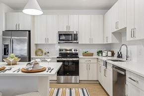 St. Augustine apartment for rent - A modern kitchen with white cabinets and stainless steel appliances.