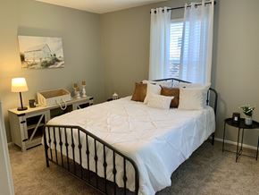 Auburn apartment for rent - Bedroom with window and carpet at The Avery at Auburn Apartments in Auburn, AL