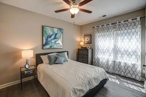Fayetteville apartment for rent - A bedroom with a bed, nightstand, and a painting on the wall.
