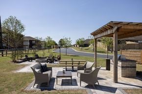 Florence apartment for rent - A patio with a table and chairs is surrounded by a grassy area.