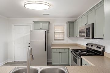 Florence apartment for rent - A kitchen with a stainless steel refrigerator and a stove top oven.